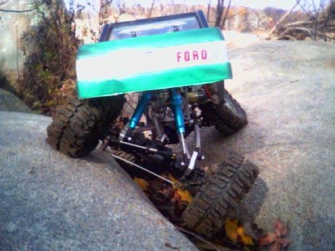 1996 Ford Bronco - RC rock crawler with Ford tailgate navigating rocky terrain.