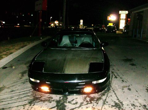 1995 Ford Probe - Front view of a black 1995 Ford Probe GT parked at night.