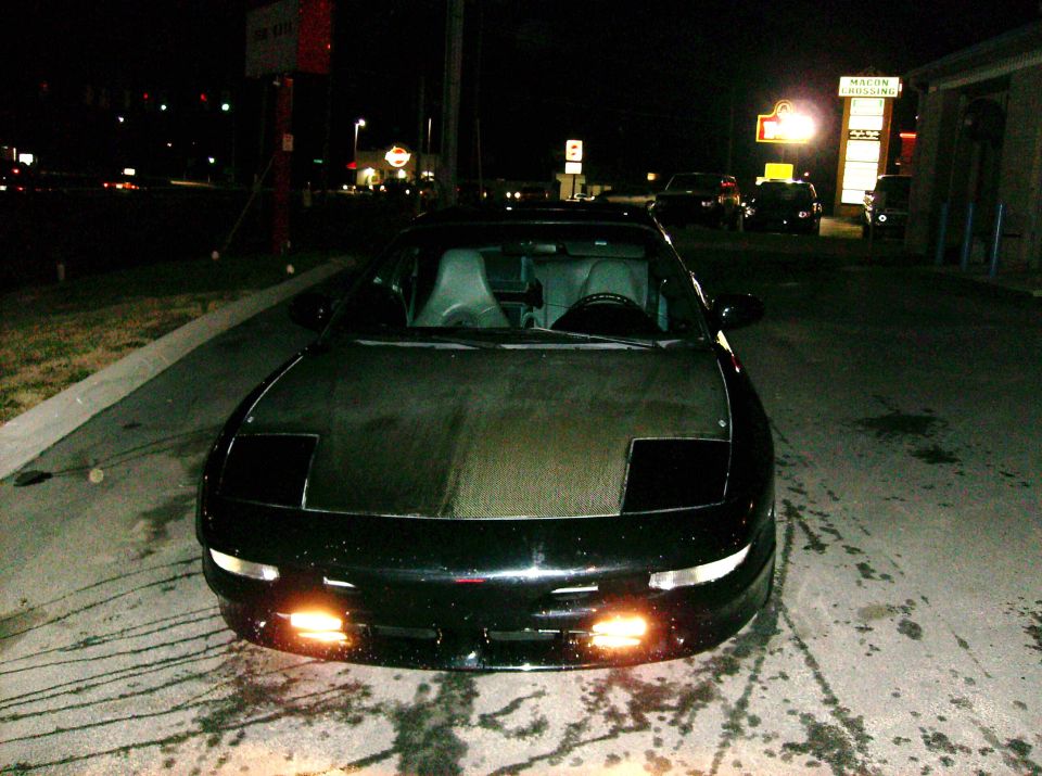 1995 Ford Probe GT front view at night, pop-up headlights down
