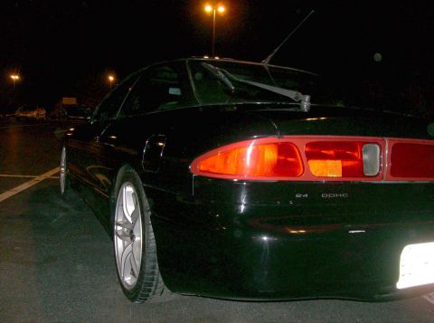 1995 Ford Probe - Rear view of a black 1995 Ford Probe GT parked at night, with visible "24 DOHC" badging.