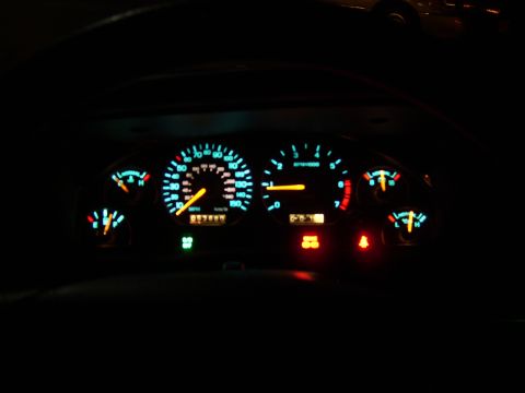 1996 Mercury Grand Marquis - The illuminated dashboard gauges glow in the dark, showing speed, RPM, fuel level, and temperature.