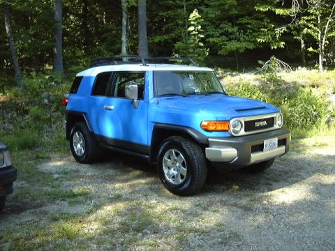 2007 Toyota Land Cruiser - 2007 Toyota FJ Cruiser in VooDoo Blue with a white roof, parked outdoors.