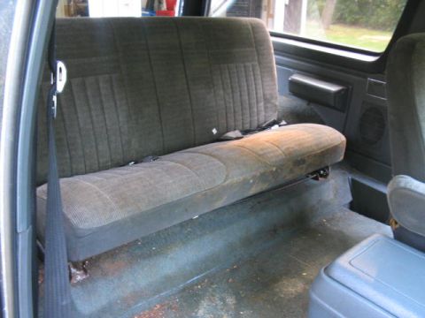 1989 Ford Bronco - Interior view of a vehicle's rear bench seat and floor area.