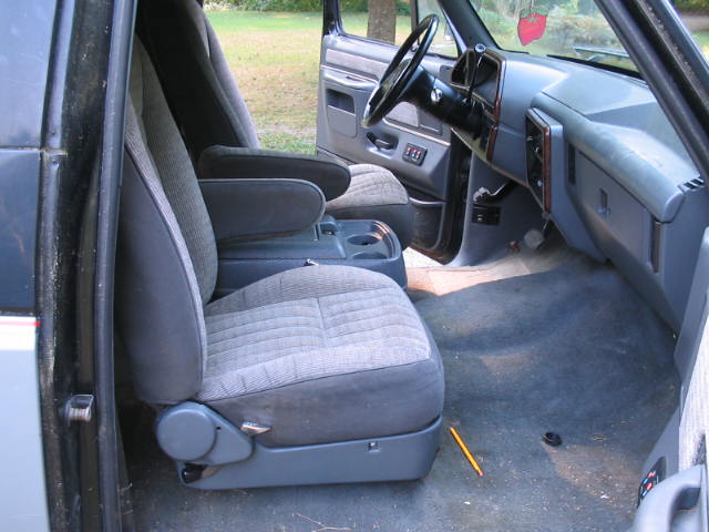 Interior of a 1989 Ford Bronco showing front seats, dashboard, and steering wheel