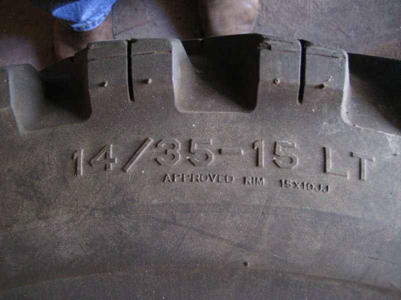 Tire sidewall stamped 14/35-15 LT, approved rim 15x10JJ, with lugged tread blocks above