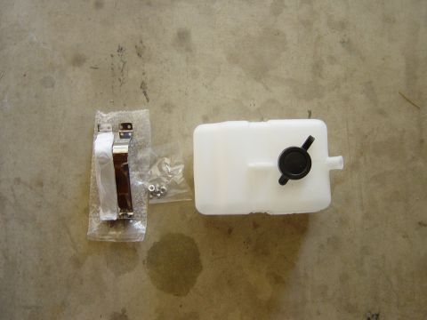 1983 Ferrari Enzo - New windshield washer fluid reservoir and mounting hardware laid out on a concrete surface.
