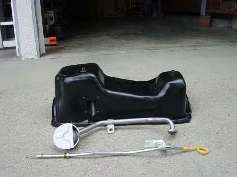 1983 Ferrari Enzo - Oil pan and dipstick are shown as separate parts on a concrete surface.