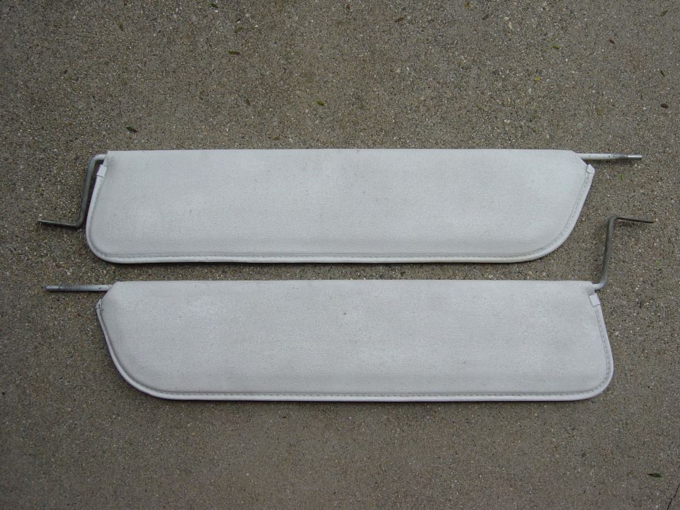 Pair of light gray sun visors with metal mounting arms