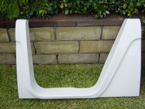 1983 Ferrari Enzo - A white fender flare part is shown against a brick wall and grass background.