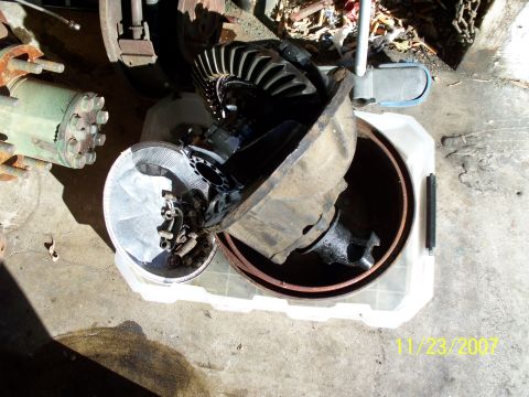 2007 Ford Ranger - Various automotive parts, including a differential and brake components, are laid out on a concrete surface.