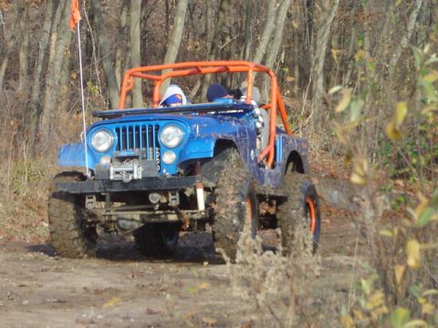 1992 Ford Bronco - Off-roading in a modified Jeep CJ-5 with an orange roll cage.