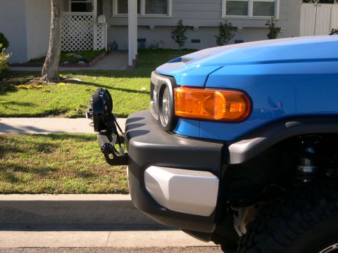 2007 Toyota FJ Cruiser - A blue 2007 Toyota FJ Cruiser is shown with an aftermarket light bar mounted to its front bumper.