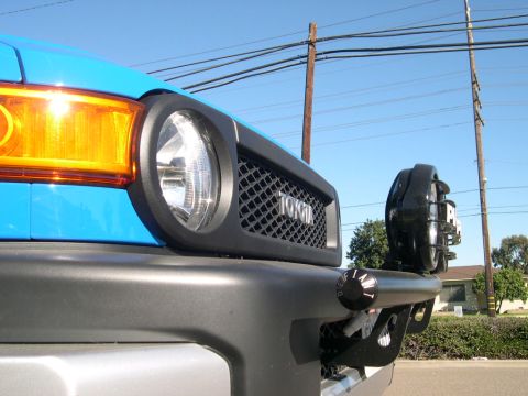 2007 Toyota FJ Cruiser - Front view of a blue 2007 Toyota FJ Cruiser, showing the grille and an aftermarket light bar.