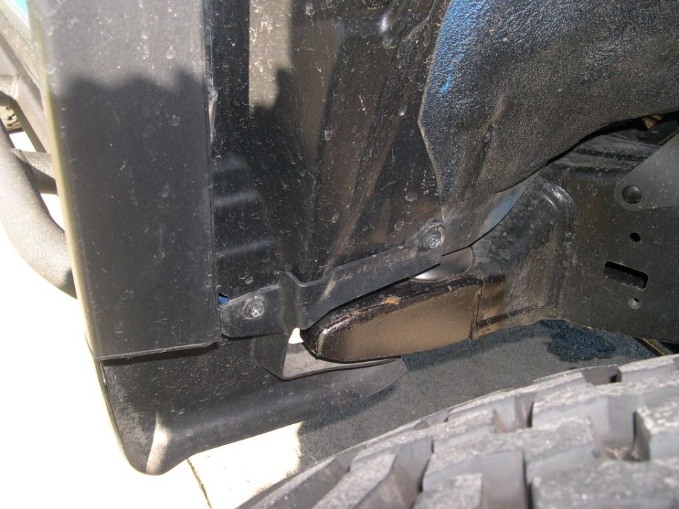 Underbody view of black truck inner fender and frame area