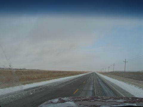 1995 Ford Bronco - Driving on a highway with snow piled on the shoulders under a cloudy sky.