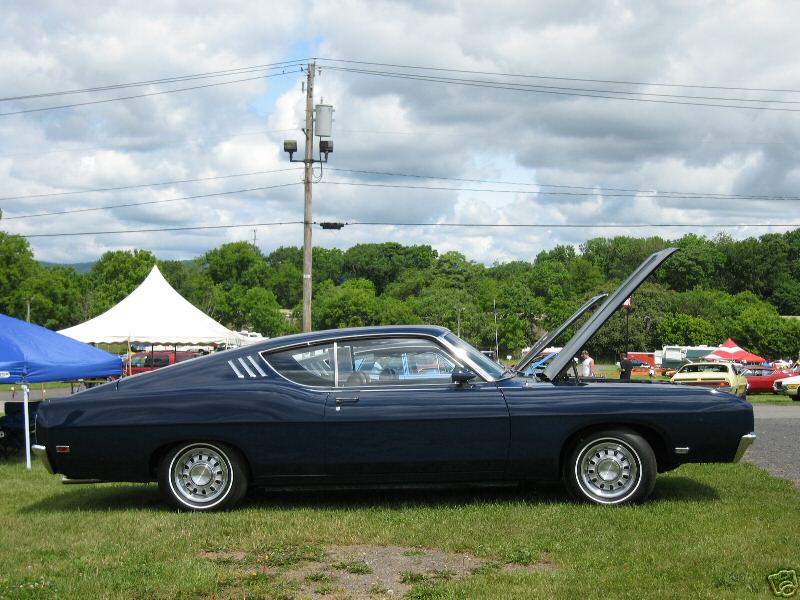 Dark blue 1969 Ford Torino coupe, side view, hood open