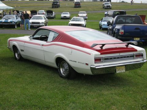 1969 Ford Torino - Rear view of a 1969 Mercury Cyclone Spoiler parked on grass at a car show.