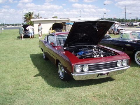 1969 Ford Torino - Front view of a maroon 1969 Ford Torino at a car show, hood raised to reveal the engine.