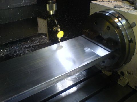 1964 Ford 427 - Machining a metal part on a lathe, using a dial indicator for precise measurement.