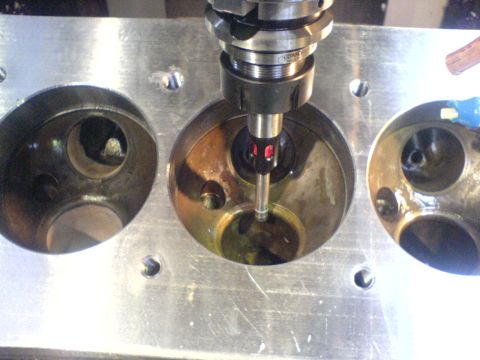 1964 Ford 427 - Machining a cylinder head with a tool, showing three chambers and visible text on the bottom right.