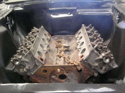 1964 Ford 427 - Engine block and cylinder heads with a chain draped across them, viewed from the front.