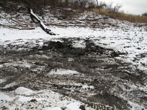 1995 Ford Bronco - Tire tracks are visible in the mud and snow on a hillside.