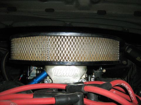 1988 Mercury Grand Marquis - Close-up of a Demon carburetor and air filter assembly under the hood.