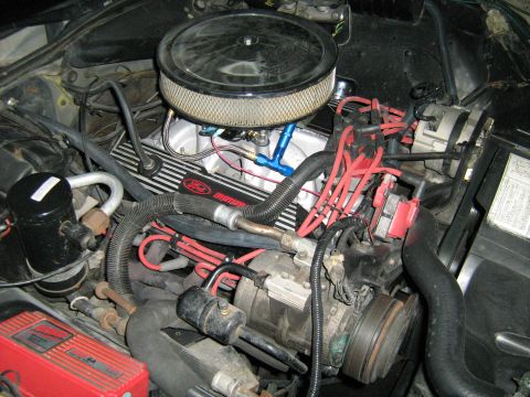 1988 Mercury Grand Marquis - A close-up view of a car's engine bay, showing the air intake, valve covers, and wiring.