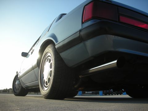 1990 Ford Mustang - Low angle shot of a 1990 Ford Mustang's rear quarter panel, showing the taillight and exhaust.