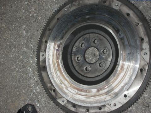 1990 Ford Mustang - Flywheel part shown in detail, with visible wear marks on its surface.