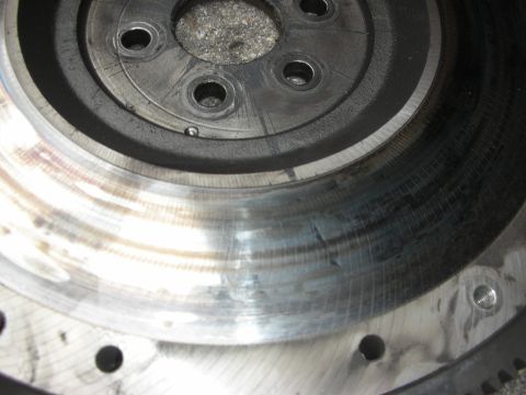 1990 Ford Mustang - This image shows a close-up of a vehicle's flywheel, highlighting wear and scoring on its surface.