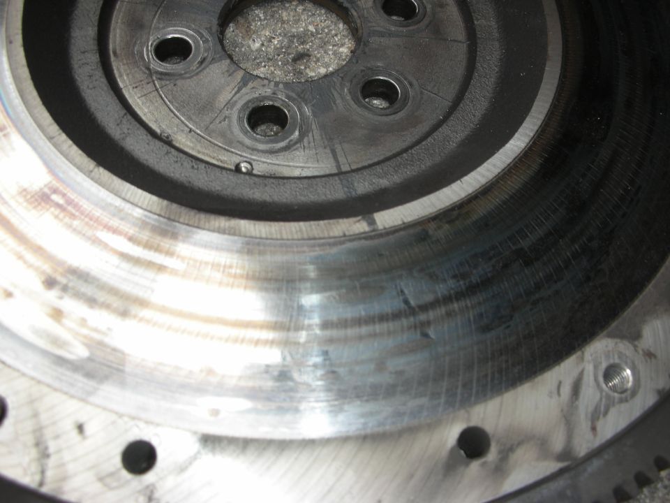 Close-up of a worn flywheel with scoring on the clutch surface