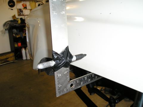 1986 Toyota Hilux - Measuring the fender of a white vehicle with a ruler and marker taped in place.