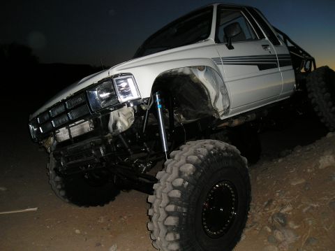 1986 Toyota Hilux - This modified 1986 Toyota Hilux features oversized tires and an aggressive suspension setup for off-road adventures.