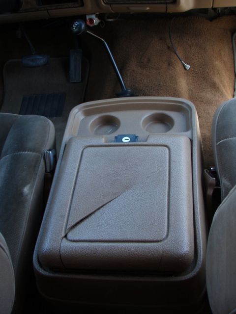 1991 Ford Bronco - Interior view of a 1991 Ford Bronco, focusing on the center console and floor shifter.