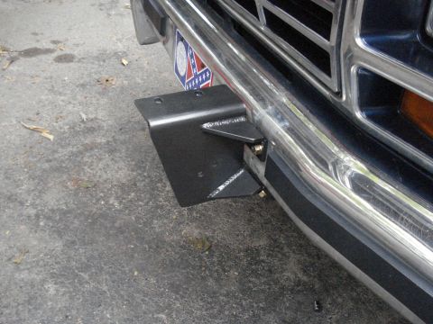1984 Ford Bronco - A custom bracket is attached to the front bumper of a vehicle, obscuring part of the grille and license plate.