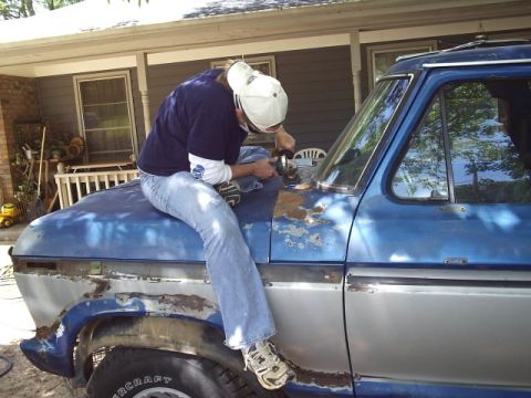 1978 Ford Bronco - Body work in progress on a blue vehicle, with rust visible on the hood and lower panels.