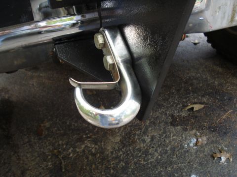 1984 Ford Bronco - Close-up of a vehicle's tow hook and bumper mounting hardware.
