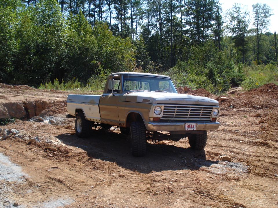 1967 Ford F-250 pickup truck, tan and white, 3q-front view on dirt road