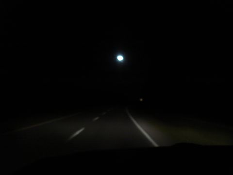 1967 Ford F-250 - Driving down a highway at night, illuminated by headlights and a distant light.