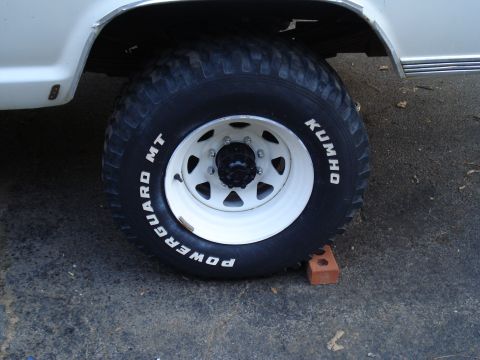 1967 Ford F-250 - Close-up of a white wheel and Kumho Powerguard MT tire on a white vehicle.