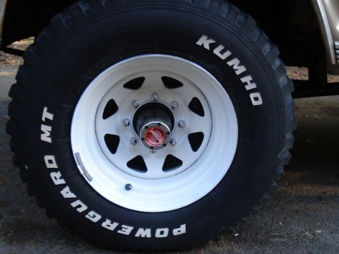 1967 Ford F-250 - Close-up of a vehicle's wheel and tire assembly, showing brand names and tread detail.