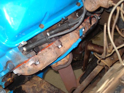 1967 Ford F-250 - This is a close-up view of an engine's exhaust manifold and spark plug wires.