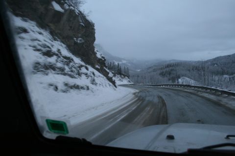 2003 Jeep TJ - Driving on a slippery mountain road in a winter landscape.