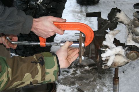2003 Jeep TJ - Working on a vehicle's axle in snowy conditions, using a clamp to secure a socket.