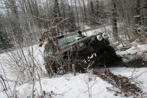 2003 Jeep TJ - Jeep Cherokee XJ navigates a snowy trail, demonstrating off-road capability in winter conditions.