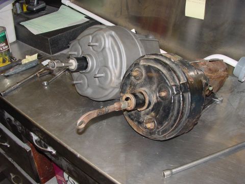 1979 Ford Bronco - Two brake boosters are shown on a workbench, likely for comparison or replacement.