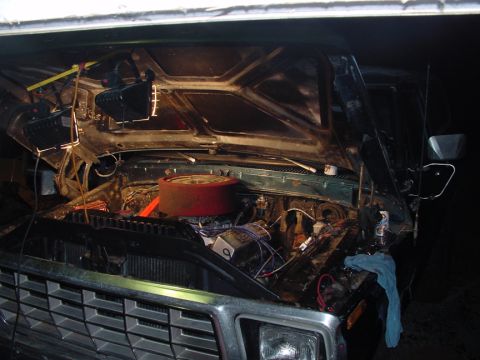 1979 Ford Bronco - The engine bay of a 1978 Ford F-150 is visible with the hood open, revealing the V8 engine and various components.