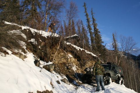 2003 Jeep TJ - Jeep TJ navigating a challenging snowy incline on a mountain road.