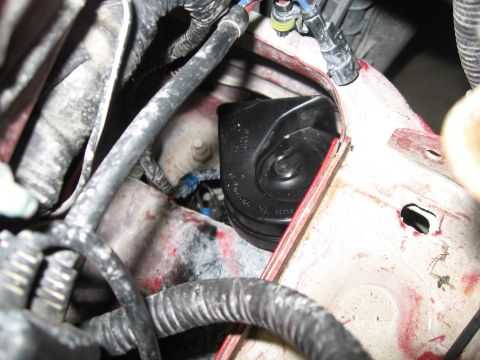 2000 Ford Ranger - Vehicle horn and wiring harness detail, likely from an engine bay or fender well area.